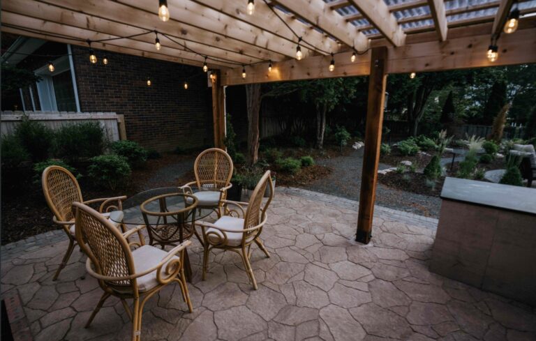 Covered outdoor patio with seating and natural stone flooring