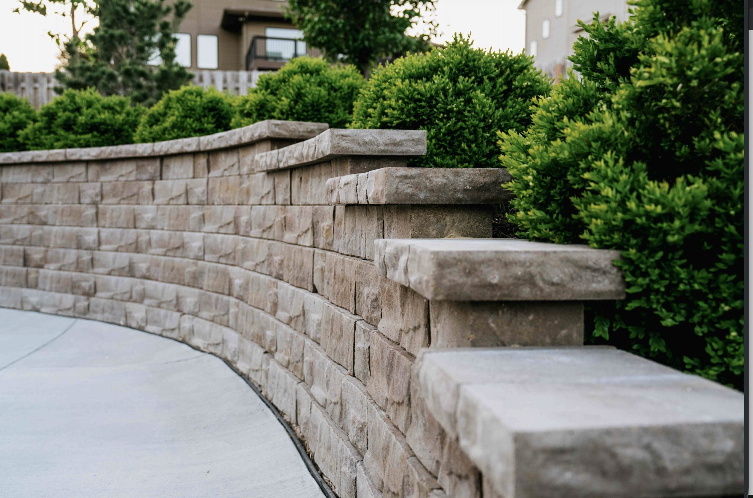 Custom hardscape retaining wall installation and backyard transformation by top-rated Omaha landscaping company